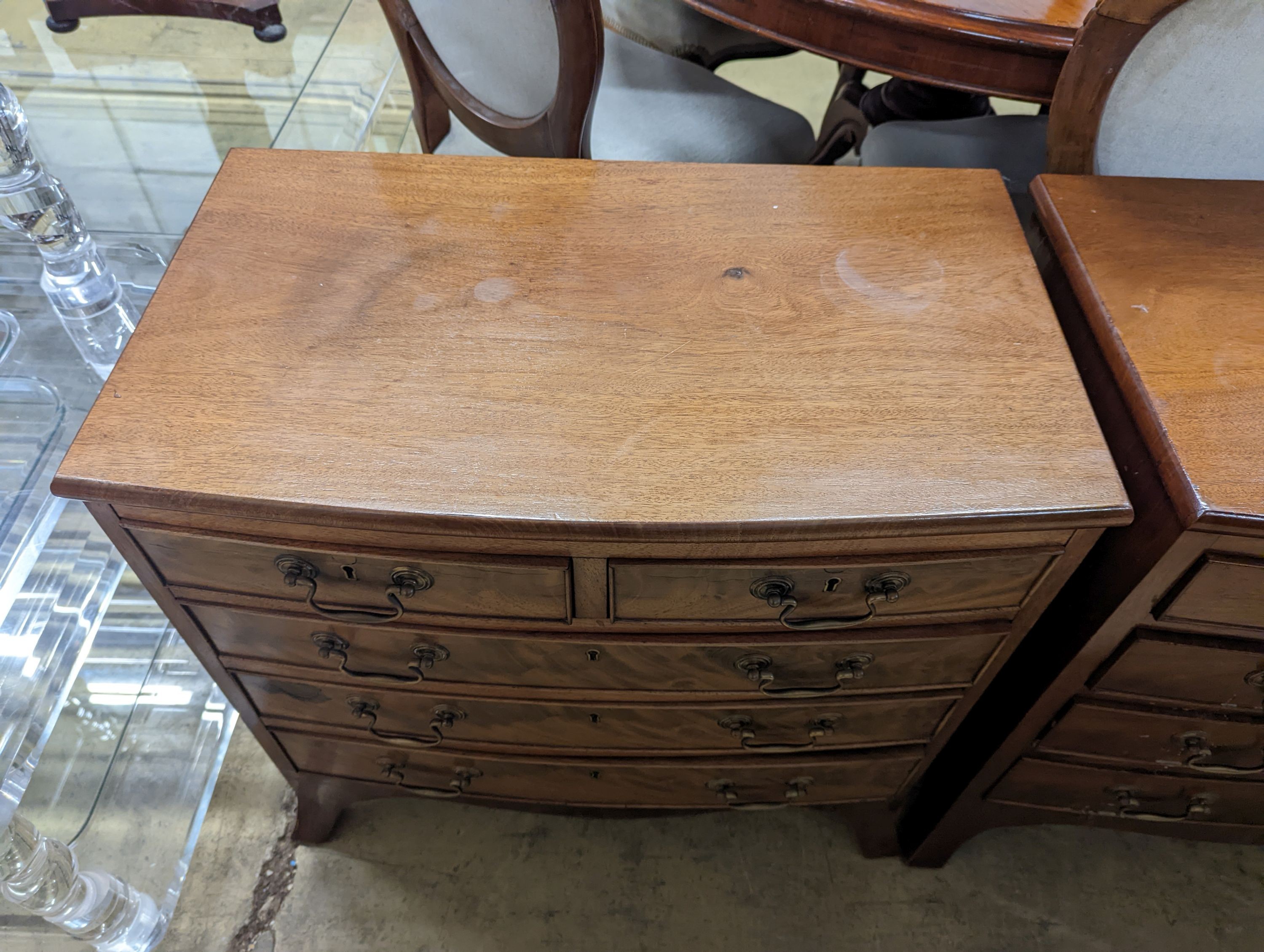 A pair of reproduction George III style bow fronted mahogany bedside chests, width 66cm, depth 39cm, height 64cm